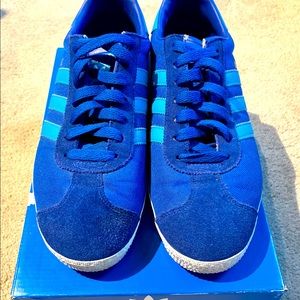 Royal blue Adidas sneakers with sky blue stripes